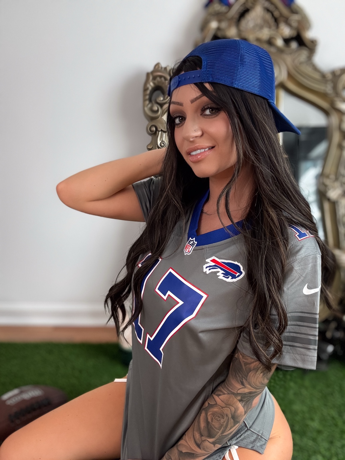 Casey Mae wearing a Buffalo football jersey and blue cap